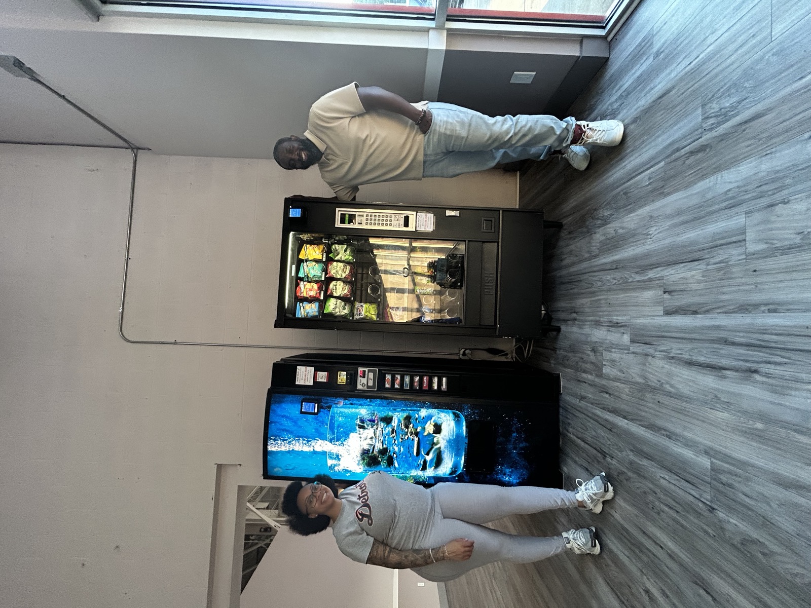 Nicholas and Ashley beside their snack and drink vending machines